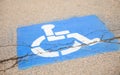 Blue handicap sign on the street - a symbol for mobility aid for people with disabilities Royalty Free Stock Photo