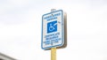 Blue handicap sign on the street - a symbol for mobility aid for people with disabilities