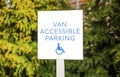 Blue handicap sign on the street - a symbol for mobility aid for people with disabilities Royalty Free Stock Photo
