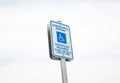 Blue handicap sign on the street - a symbol for mobility aid for people with disabilities Royalty Free Stock Photo