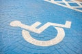 Blue handicap wheel chair marking a reserved parking space Royalty Free Stock Photo