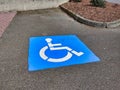 Blue handicapped parking paint marker in a parking lot outdoors