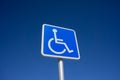 Blue Handicapped Parking Sign with Blue Sky Background Royalty Free Stock Photo