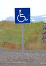 Blue handicapped parking sign for disabled drivers Royalty Free Stock Photo