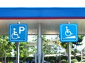 Blue handicapped parking sign at petrol station. Royalty Free Stock Photo