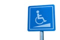 Blue handicapped parking symbol in car park on white isolated background. Royalty Free Stock Photo