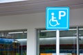 Blue handicapped sign mark parking spot, disabled parking permit sign on pole with convenience store in gas station Royalty Free Stock Photo