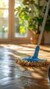 Blue-Handled Mop on Wooden Floor Royalty Free Stock Photo