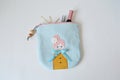 Blue handmade zipper pouch with cute doll, hair pins, mascara and hair tweezers