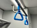 Blue handrails in a public transport car. Blue Hand Straps in Urban Train Interior Royalty Free Stock Photo