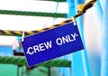 Blue hanging sign with Crew only words