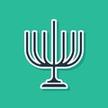 Blue Hanukkah menorah icon isolated on green background. Hanukkah traditional symbol. Holiday religion, jewish festival of Lights Royalty Free Stock Photo