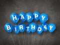 Blue happy birthday air balloons on a concrete background Royalty Free Stock Photo