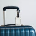Blue hardshell suitcase with a silver telescopic handle extended. A white luggage tag Royalty Free Stock Photo