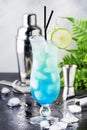 Blue Hawaii or Blue Lagoon - summer alcoholic cocktail with vodka, liqueur, tonic, pineapple juice and ice, in high Hurricane