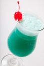 Blue Hawaiian cocktail with a cherry. White background Royalty Free Stock Photo