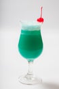 Blue Hawaiian cocktail with a cherry. White background Royalty Free Stock Photo