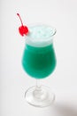Blue Hawaiian cocktail with a cherry. White background Royalty Free Stock Photo