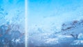 Blue haze on glass of car window. Frost texture. Wallpaper with white hoar frost on window pane. Soft focus. film grain Royalty Free Stock Photo