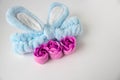 A blue headband with rabbit ears and pink soap roses. Body care. Easter concept. Place for your text