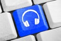 Blue headphones button on the keyboard Royalty Free Stock Photo