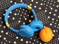 Blue headphones and a ripe peach