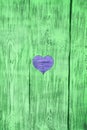 Blue heart carved in a green wooden board. Background. Royalty Free Stock Photo