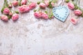 Blue heart and pink roses flowers on grey vintage textured background. Royalty Free Stock Photo