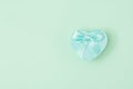 Blue heart shape decorative gift box with blue bow on mint green background. Valentine`s day, love, wedding, Royalty Free Stock Photo