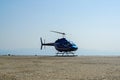 Blue helicopter flying in grey cloudy skies Royalty Free Stock Photo