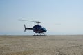 Blue helicopter flying in grey cloudy skies Royalty Free Stock Photo