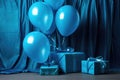 blue helium balloons and a matching wrapped gift