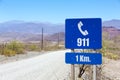 Blue help 911 sign post on Route 40 in Salta Province, Argentina