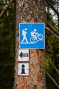 Blue hiking and mountain bike trail sign on a tree Royalty Free Stock Photo