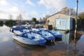 Blue hire boats on flooded river