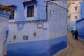 Blue historical streets of Morocco. Narrow and old streets. Muslim clothing styles.