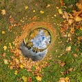 blue hole sphere or globe little planet inside green dry grass with yellow leaf frame background Royalty Free Stock Photo