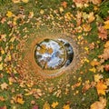 blue hole sphere or globe little planet inside green dry grass with yellow leaf frame background Royalty Free Stock Photo