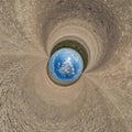 blue hole sphere little planet inside gravel sand round frame background Royalty Free Stock Photo