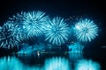 Blue Holiday fireworks above water with reflection on the black sky background Royalty Free Stock Photo