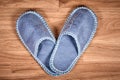 Blue home slippers on a brown wooden floor Royalty Free Stock Photo