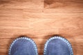 Blue home slippers on a brown wooden floor Royalty Free Stock Photo