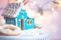 Blue homemade gingerbread house cookie on white background with Royalty Free Stock Photo