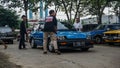 Blue Honda Civic Wonder SB3 hatchback on parking lot surrounded by three men Royalty Free Stock Photo