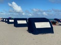 Blue hooded beach chairs or beach cabins at Baltic Sea or North sea