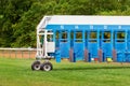 Blue horse racing starting gate on start by tractor machine at equiestrian racehorse hippodrome. Outdoor sport