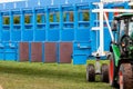 Blue horse racing starting gate on start by tractor machine at equiestrian racehorse hippodrome. Outdoor sport