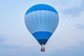 Blue hot air balloon above the land