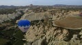 Blue Hot Air Balloon Flying Over Cappadocia Near Uchisar Castle Royalty Free Stock Photo