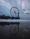 Blue hour beach water reflection panorama of sky view ferris wheel on pier of Scheveningen The Hague Netherlands Europe Royalty Free Stock Photo